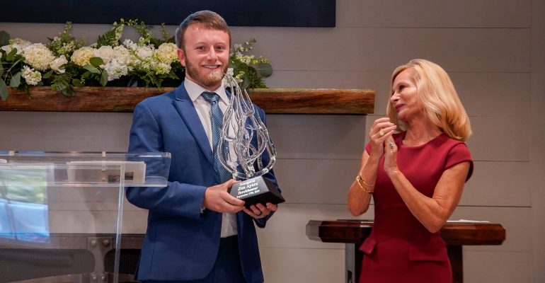 Janet Ayers applauds recipient of Torchbearer Award on Founders Day